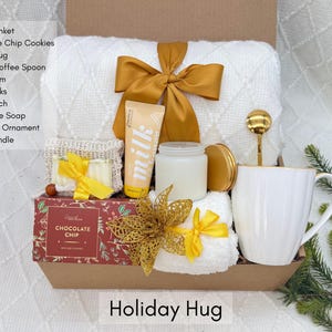 Cozy Christmas gift box with blanket, candle and holiday treats, ready to gift