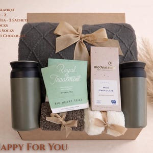 So Happy for You gift box with soft pastel tones, cozy blanket, candle and thoughtful items styled for a warm congratulations gift