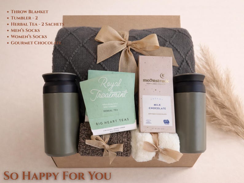 So Happy for You gift box with soft pastel tones, cozy blanket, candle and thoughtful items styled for a warm congratulations gift