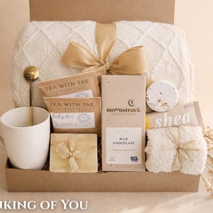 Thoughtful sympathy package for her containing a prayer shawl or throw blanket and relaxation items