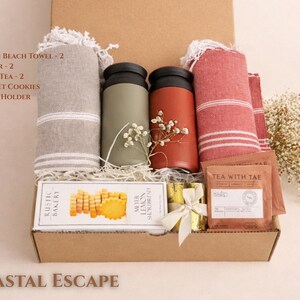 Coastal Escape gift box with soft blue tones, spa items, candle and relaxing essentials in a kraft box inspired by a beach theme