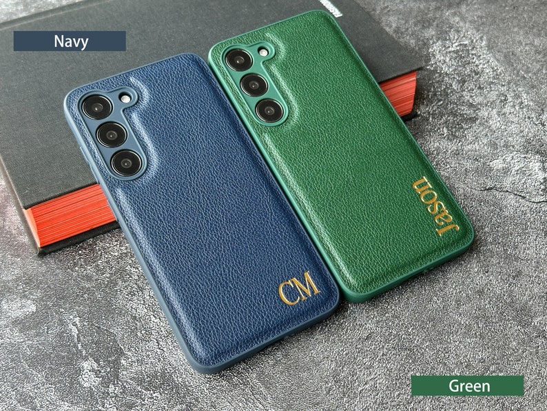 May include: Two personalized phone cases, one navy blue with the initials "CM" and one green with the name "Jason".