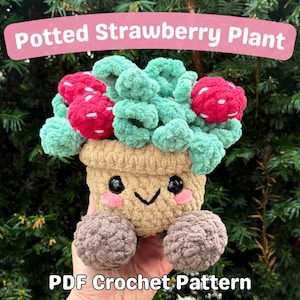 May include: A crochet pattern for a potted strawberry plant. The plant is green and has red strawberries. The pot is brown and has a cute face. The pattern is available as a PDF download.