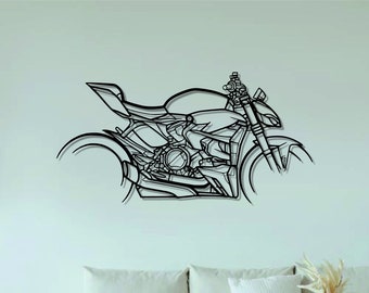 May include: A black metal motorcycle silhouette wall art hanging on a white wall above a white couch with pillows and a woven rug. The motorcycle is in a minimalist style with a focus on the engine and wheels. The wall art is a great addition to any home decor.