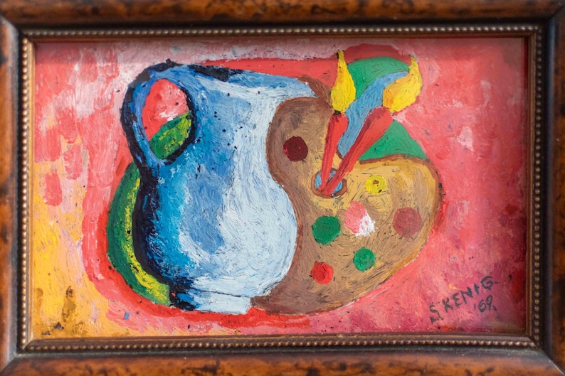 May include: A framed painting of a blue pitcher and a brown artist's palette with colorful paint on it. The background is a bright red and yellow. The painting is signed "S. Kenig 68."
