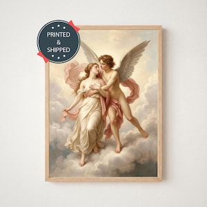 May include: A framed print of a classical painting depicting two figures, one winged, embracing amidst clouds. The figures are draped in flowing fabrics, with a palette of soft pinks, creams, and browns. The print is in a light-colored wooden frame.
