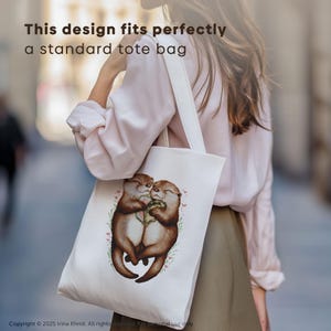 May include: A white tote bag with a design of two otters hugging. The otters are brown and have pink noses. The design is surrounded by small pink flowers and green leaves.