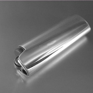 May include: A shiny, silver-colored lighter with a smooth, reflective surface. The lighter has a rectangular shape with rounded edges and a small, textured wheel for ignition. The design is sleek and modern, suitable for everyday use.