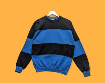 May include: A blue and black striped sweatshirt with long sleeves and a crew neck.