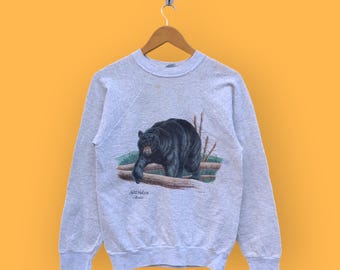 May include: A grey sweatshirt with a black bear graphic on the front. The bear is walking on a log and there are trees in the background. The text "Appalachian" and "Bears" is printed below the bear.