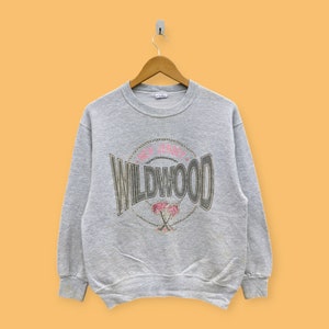 May include: Gray sweatshirt with a vintage-style graphic print of "Wildwood, New Jersey" with palm trees.
