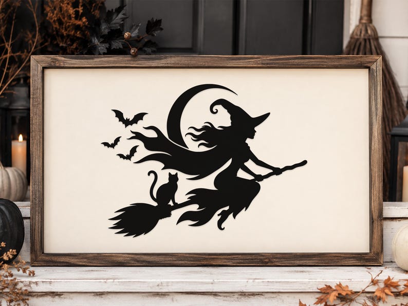 May include: A rectangular wooden sign with a cream-colored background featuring a black silhouette of a witch flying on a broomstick with a cat, a crescent moon, and three bats. The sign is enclosed in a dark brown stained wooden frame.