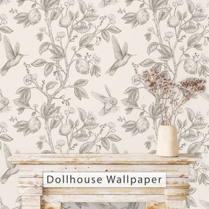 May include: A white background with a black and white floral pattern featuring hummingbirds and lemons. The pattern is repeated throughout the image. The text "Dollhouse Wallpaper" is printed on a white wooden surface in front of the wallpaper.