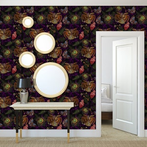 May include: A hallway with a dark purple wallpaper featuring a repeating pattern of owls, hearts, keys, and ferns. The wallpaper has a vintage, gothic aesthetic. There is a console table with a lamp and four gold-framed mirrors on the wall.