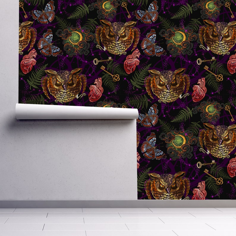 May include: A seamless pattern featuring embroidered owls, butterflies, keys, hearts, and fern leaves on a dark purple background. The design is perfect for fabric, wallpaper, or other creative projects.