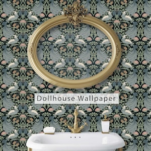 May include: A gold oval frame with a decorative design hangs on a dark blue wallpaper with a repeating pattern of peacocks and flowers. The text "Dollhouse Wallpaper" is printed below the frame. A white porcelain sink with a gold faucet is in the foreground.