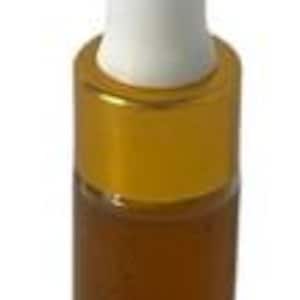 May include: A small glass bottle with a golden cap and a white dropper. The bottle contains a dark amber liquid. The product is likely a cosmetic or essential oil.