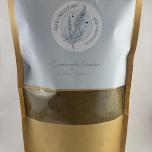 May include: A brown paper bag with a white label that says "Cordoncillo Powder 8oz Honduras Grown". The bag is filled with a brown powder.
