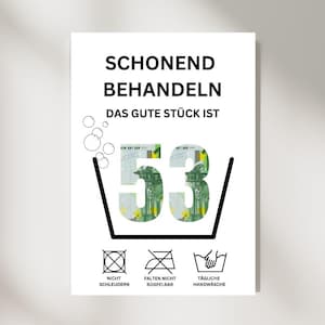 May include: A white sign with black text that reads "Schonend Behandeln Das Gute Stück Ist 53/" with a picture of a 53 Euro bill inside a washing tub. Below the text are three symbols: a circle with a cross through it, a circle with a cross through it and a line through it, and a washing tub with a hand in it. The text below the symbols reads "Nicht Schleudern", "Falten Nicht Bügelbar", and "Tägliche Handwäsche".
