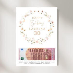 May include: A birthday card featuring a floral wreath, the words "Happy Birthday Sabrina 30" in gold script, and a graphic of a 10 Euro note. The card also includes German text.