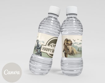 May include: Two clear plastic water bottles with white caps. Each bottle has a label with a dinosaur illustration and the words "HAPPY BIRTHDAY". The labels have a beige background with a mountain and tree design.
