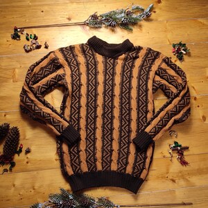 May include: A brown and black striped knitted jumper with a turtleneck.