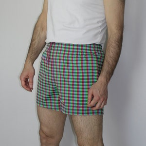 May include: Green, pink, and blue plaid shorts with a white drawstring.