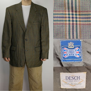 May include: A brown and green plaid blazer with two buttons. The blazer has a woven in the British Isles label and a Desch Town & Country label.
