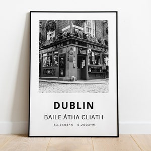 May include: Black and white photograph of a pub in Dublin, Ireland. The pub is called "The Temple Bar" and has a sign above the door. The photo is framed in a black frame.