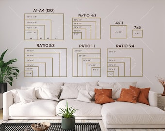 May include: A white wall with a gold frame around different size rectangles with measurements in inches. The rectangles are labeled with different ratios: 3:2, 4:3, 1:1, 5:4, and 14x11, and 7x5. The wall is behind a white couch with orange pillows.