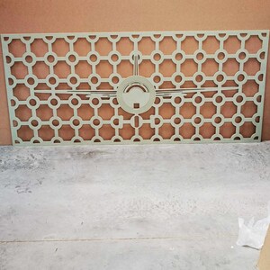 May include: A light green, rectangular decorative panel with a geometric pattern of circles and a central design. The panel is made of a solid material and is suitable for interior design or architectural applications.