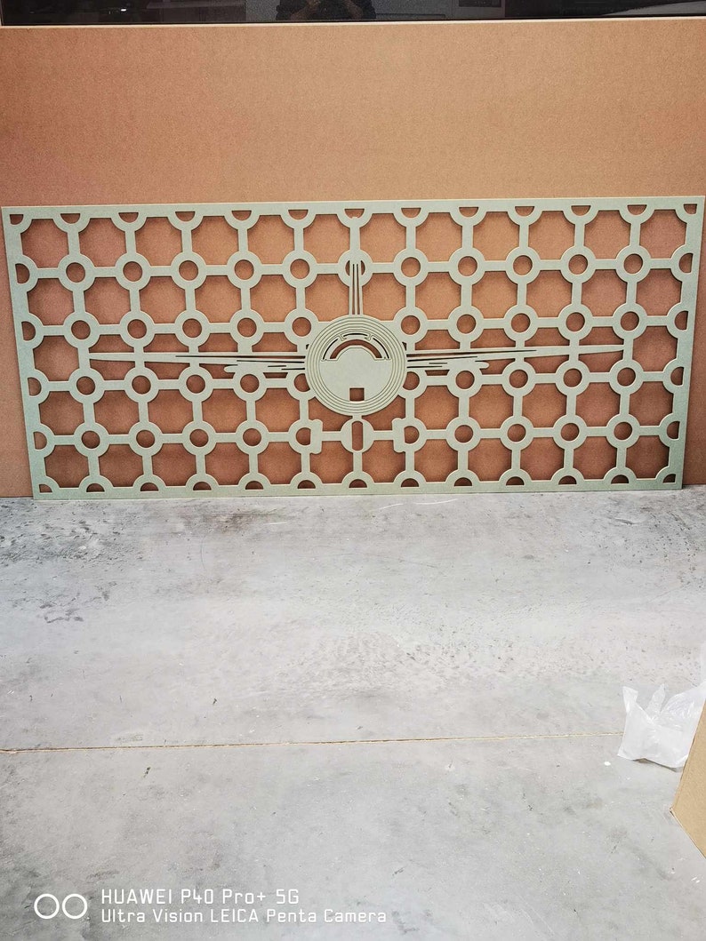 May include: A light green, rectangular decorative panel with a geometric pattern of circles and a central design. The panel is made of a solid material and is suitable for interior design or architectural applications.