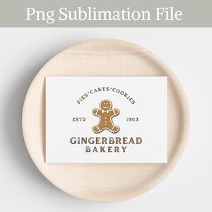 May include: A white card with a brown gingerbread man logo. The logo says "Pies Cakes Cookies" in a circle around the gingerbread man. Below the gingerbread man, it says "ESTD 1903" and "Gingerbread Bakery".