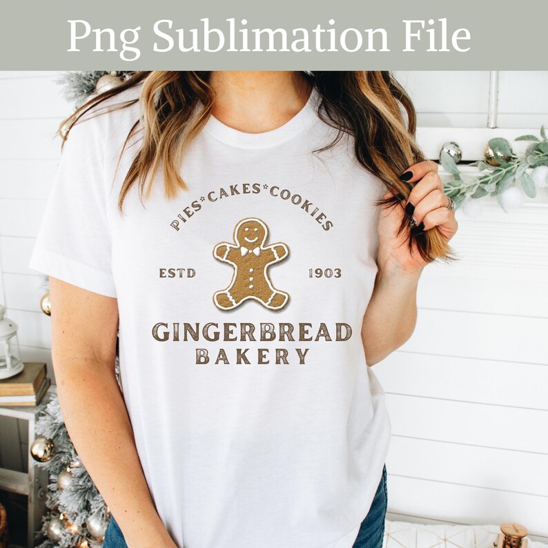 May include: White t-shirt with a brown gingerbread man graphic and the text "Pies Cakes Cookies Est'd 1903 Gingerbread Bakery".
