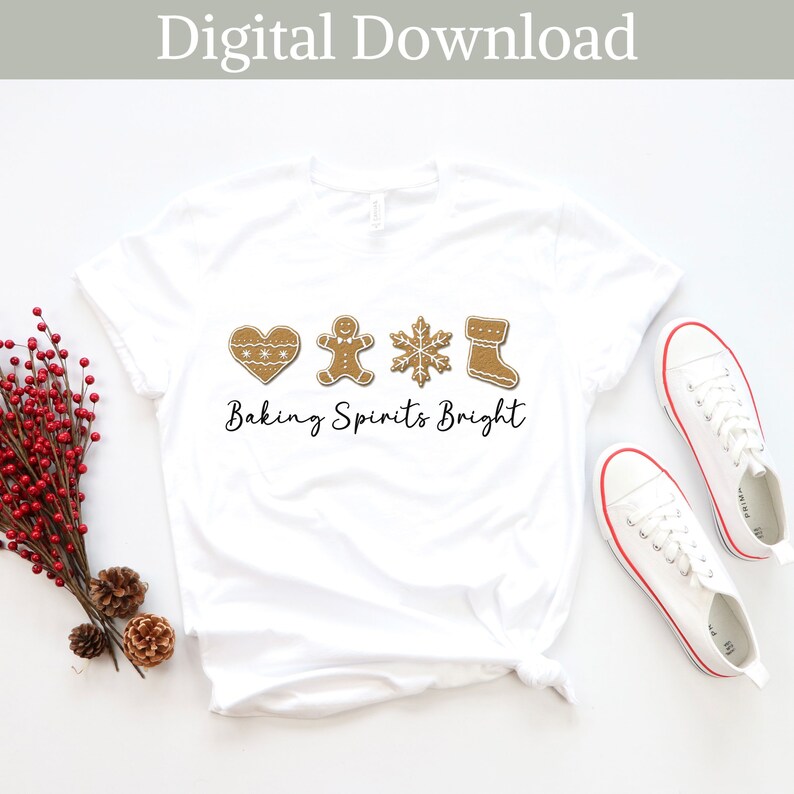 May include: White t-shirt with a gingerbread cookie design and the text "Baking Spirits Bright".