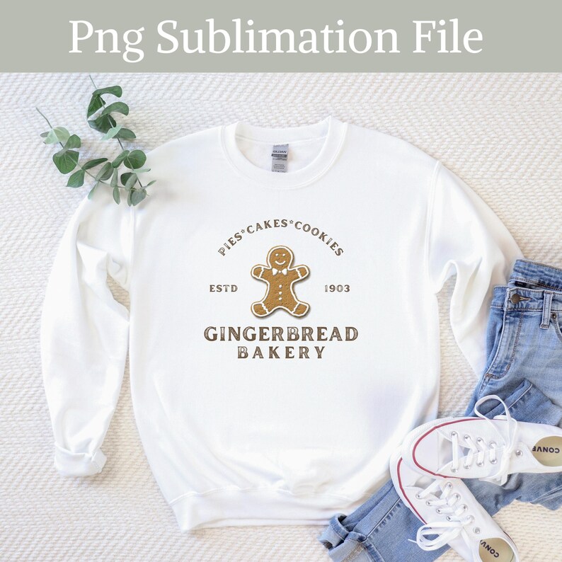 May include: White sweatshirt with a brown gingerbread man graphic and the text "Pies Cakes Cookies Est. 1903 Gingerbread Bakery".