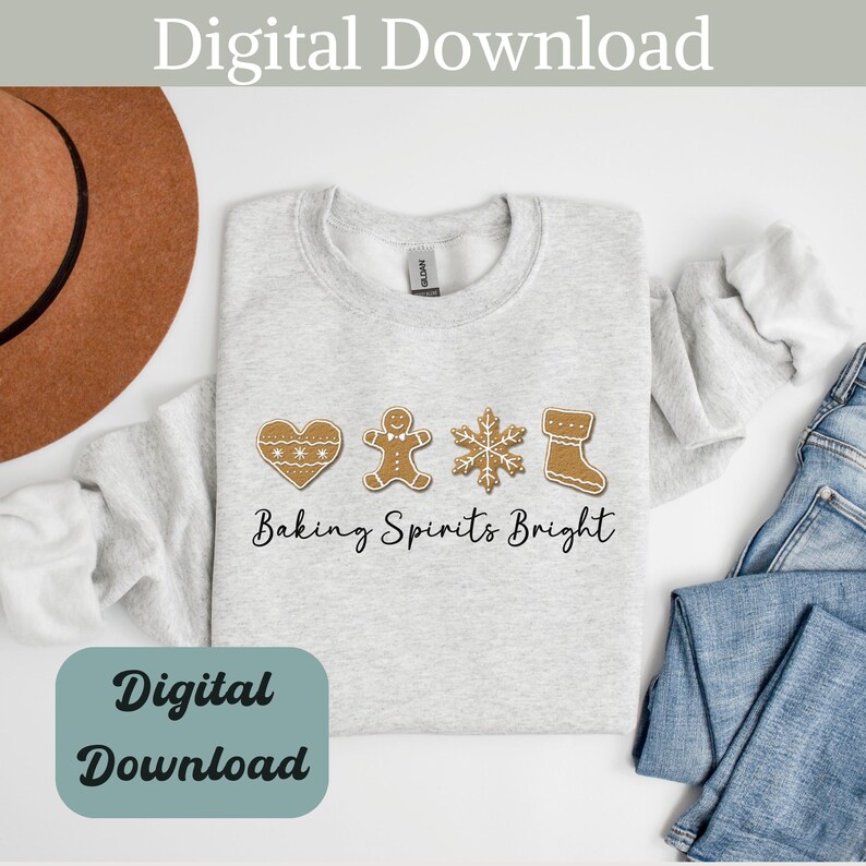May include: A gray sweatshirt with a Christmas-themed design featuring gingerbread cookies in the shape of a heart, gingerbread man, snowflake, and stocking. The text "Baking Spirits Bright" is printed below the cookies.