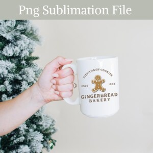 May include: White ceramic mug with a gingerbread man graphic and the text "Pies Cakes Cookies Estd 1903 Gingerbread Bakery".