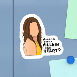 May include: A sticker with a cartoon illustration of a woman with long brown hair wearing a yellow top. The text on the sticker reads "Would you hand a villain your heart?"