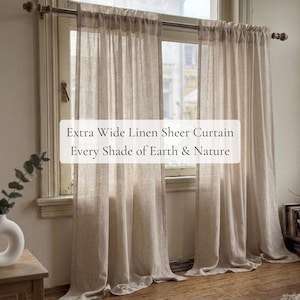Può includere: Due tende in lino beige extra larghe e semitrasparenti appese a un bastone di metallo sopra una finestra. Il testo sull'immagine recita: Extra Wide Linen Sheer Curtain, Every Shade of Earth & Nature. Il tessuto presenta una trama visibile.