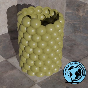 May include: A green vase made of a series of stacked spheres. The vase is sitting on a checkered surface.