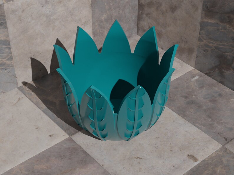 K&ouml;nnte beinhalten: T&uuml;rkise Keramikvase mit einem einzigartigen Blattdesign. Die Vase hat eine breite &Ouml;ffnung und einen abgerundeten Boden.
