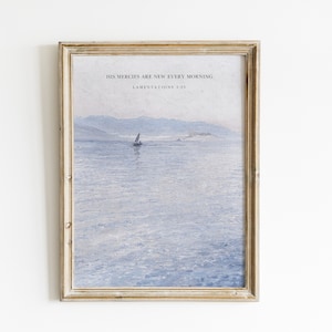 May include: A framed print with a watercolor painting of a sailboat on a calm body of water. The text "His mercies are new every morning. Lamentations 3:23" is printed at the top of the image.