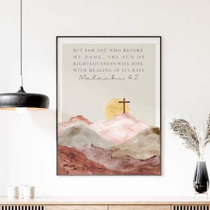 May include: Framed art print featuring a watercolor landscape with mountains, a sun, and a cross. The print includes the text "BUT FOR YOU WHO REVERE MY NAME, THE SUN OF RIGHTEOUSNESS WILL RISE WITH HEALING IN ITS RAYS Malachi 4.2".
