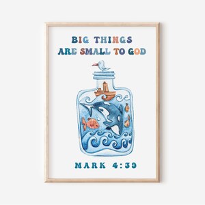 May include: Watercolor print featuring a blue bottle with an orca, fish, and a boat inside. The text "BIG THINGS ARE SMALL TO GOD" and "MARK 4:39" are displayed in colorful letters. The artwork is framed in a light wood frame.
