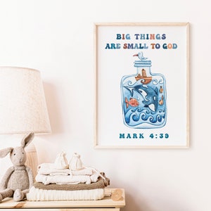 May include: Watercolor print in a wooden frame featuring a blue bottle with an orca, fish, and a boat. The text "BIG THINGS ARE SMALL TO GOD" and "MARK 4:39" are displayed in blue and brown.