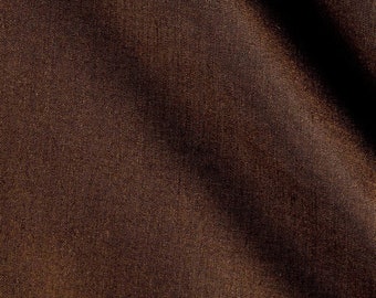 May include: Close-up of a brown fabric with a smooth, textured surface. The fabric has a subtle sheen and is slightly creased.