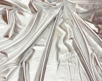 May include: Silver metallic fabric with a wrinkled, crinkled texture. The fabric is smooth and shiny.