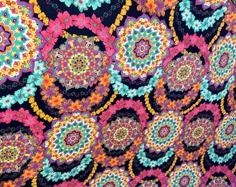 May include: A black fabric with a colorful mandala pattern. The fabric features a repeating design of circular patterns with intricate details in shades of pink, yellow, orange, blue, and green.
