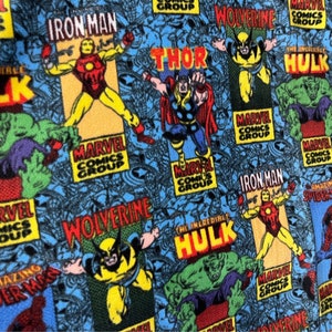Peut inclure: Un tissu bleu avec un motif r&eacute;p&eacute;t&eacute; de personnages de Marvel Comics, dont Iron Man, Thor, Wolverine et The Incredible Hulk. Le tissu pr&eacute;sente le logo de Marvel Comics Group et les noms des personnages dans une typographie de style bande dessin&eacute;e.
